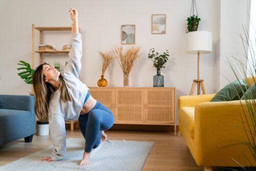 woman doing yoga to achieve wellness goals