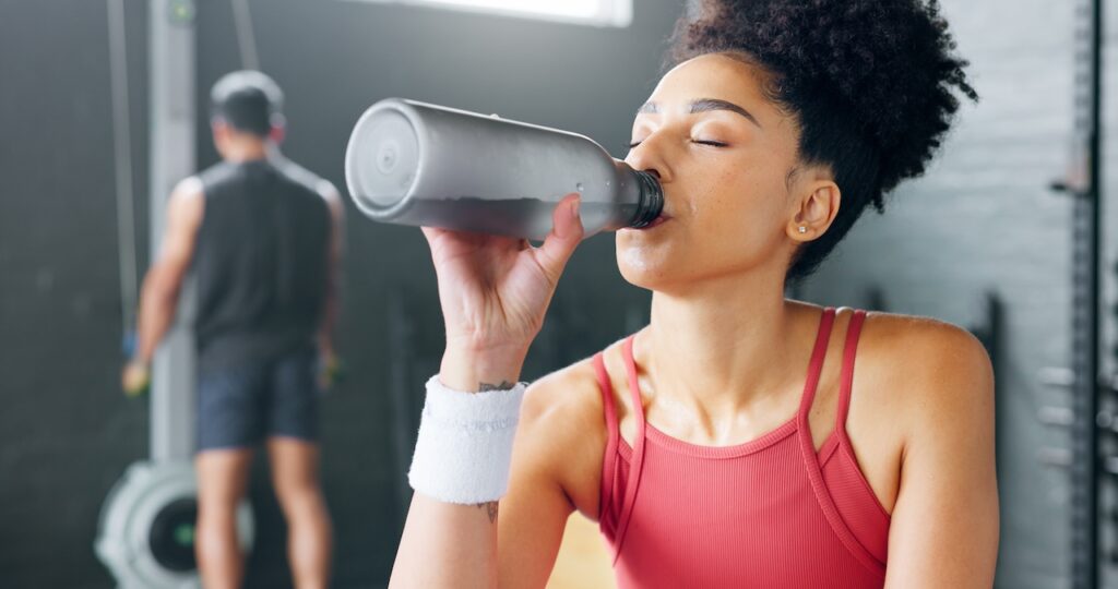 woman drinking preworkout after exercising