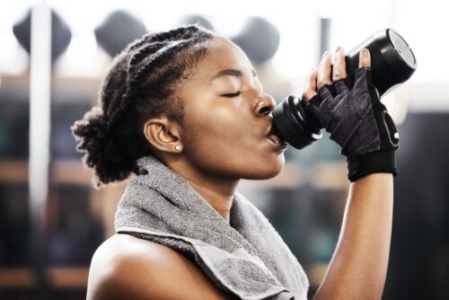 woman drinking pre-workout
